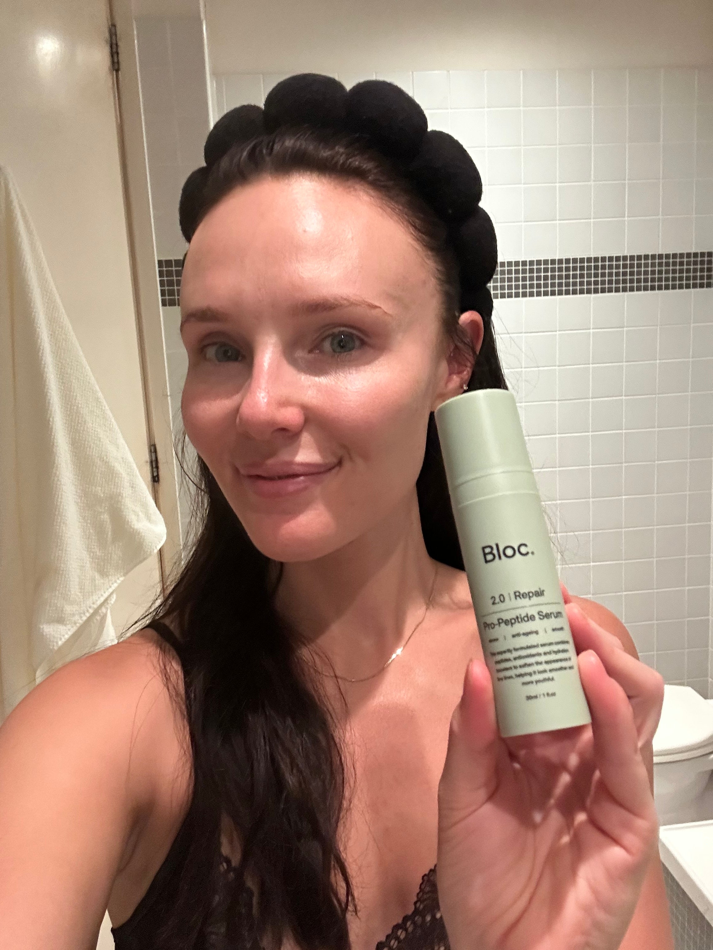 Applying Bloc Pro-Peptide Serum to the face